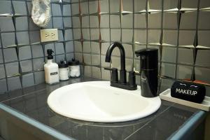 a bathroom counter with a white sink with at An-Garo Ko-Zy Spaces in Saint Johnʼs