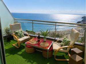a balcony with a table and chairs and the ocean at Blue Salou in Salou