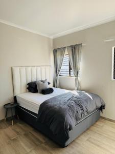 a bedroom with a large bed with a window at Gottys Lagoon Stay in Walvis Bay
