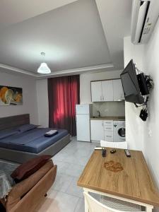 a small living room with a bed and a kitchen at Sea flavor 2 in Shëngjin