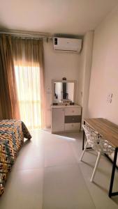 a bedroom with a bed and a table and a mirror at Solara in Hurghada