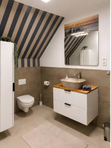 a bathroom with a sink and a toilet at Gaestehaus Nuke in Langeneß +50 photos