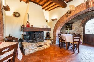 a dining room with a table and a fireplace at Agriturismo Scannano in Serre di Rapolano