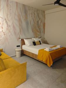 a bedroom with a large bed and a chair at Aggeliki Apartment in Skiathos