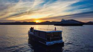 a boat in the water next to a cruise ship at Aquaïa, Saint-Tropez by sea in Cogolin