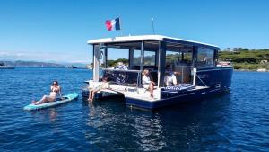 a group of people sitting on a boat in the water at Aquaïa, Saint-Tropez by sea in Cogolin