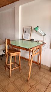 a desk with a lamp and a chair and a table at Loft D-Oro in Comodoro Rivadavia