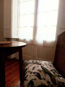 a room with a table and a chair and a window at El Café I in Nava