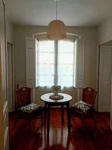 a room with a table and two chairs and a window at El Café I in Nava