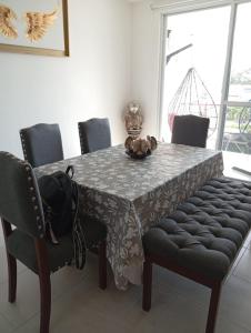 a dining room table with a table cloth and chairs at Habibi Cocoyoc in Cocoyoc