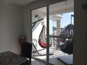 a room with a balcony with swings on the porch at Habibi Cocoyoc in Cocoyoc