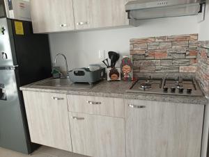 a kitchen with a stove and a counter top at Habibi Cocoyoc in Cocoyoc