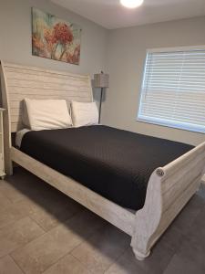 a large bed in a bedroom with a window at Home Away from Home with Heated Pool in New Port Richey