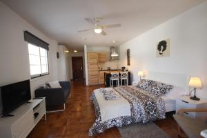 a bedroom with a bed and a living room at Studio Sunset, sea view, Costa Adeje in Adeje