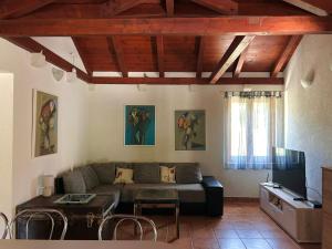 a living room with a couch and a table at Villa Olive in Dol