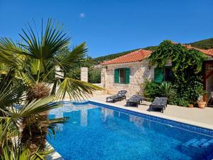 a villa with a swimming pool next to a house at Villa Olive in Dol