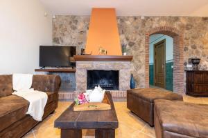 a living room with a couch and a fireplace at Masia Garriga in Tarragona