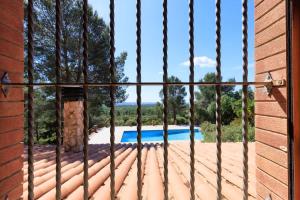 a view from a window of a pool at Masia Garriga in Tarragona