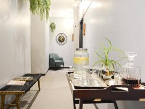 a living room with a table and a chair at The Siding Apartments in Hilton