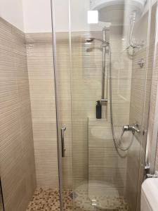 a shower with a glass door in a bathroom at Guest House Nova in Mostar +39 photos