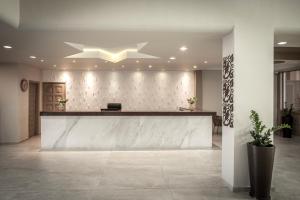 a lobby with a reception desk in a building at Electra Beach Holiday Village in Ayia Napa +37 photos