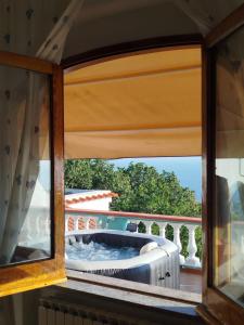 a window with a view of a balcony at Villa Gesualda in Serrara Fontana