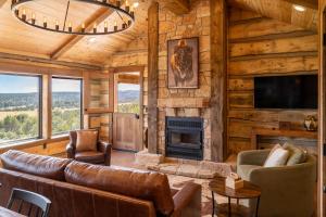 a living room with a couch and a fireplace at Zion Mountain Ranch in Mount Carmel Junction