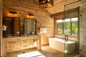 a bathroom with a tub and a glass shower at Zion Mountain Ranch in Mount Carmel Junction +262 photos
