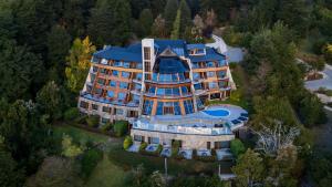 an aerial view of a large mansion with a blue roof at Sol Arrayan Hotel & Spa in Villa La Angostura