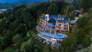 an aerial view of a large house in the forest at Sol Arrayan Hotel & Spa in Villa La Angostura