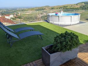 a patio with a bench and a hot tub at Gîte du Vieux Cuvage in Vaux-en-Beaujolais