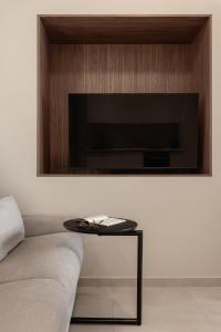 a living room with a couch and a table at Sola District Volos in Volos