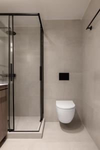 a bathroom with a shower and a toilet at Sola District Volos in Volos