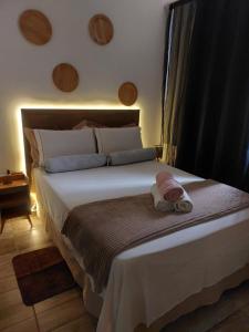 a bedroom with a bed with a towel on it at Proximo a Ipanema e Arpoador,confortavel e util! in Rio de Janeiro