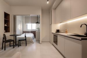 a kitchen with a sink and a table in a room at Sola District Volos in Volos
