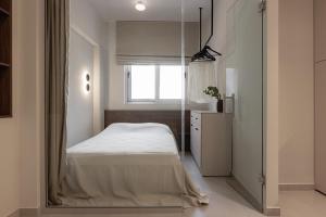 a bedroom with a bed and a large mirror at Sola District Volos in Volos +109 photos