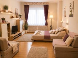 a living room with a bed and a couch at Andy's Home Central Apatment in Budapest