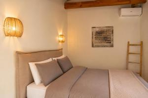 a bedroom with a bed with two pillows at Niobe Luxury Residence in Loutraki