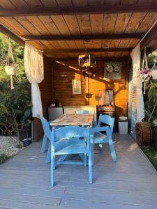 a blue table and chairs on a patio at Cabana Maya in Corbu +43 photos