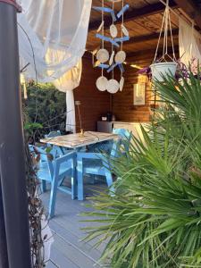 a patio with a blue table and blue chairs at Cabana Maya in Corbu