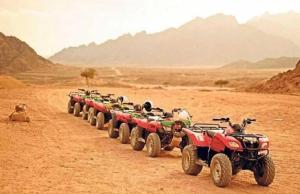 a row of atvs and at bikes in the desert at Luxor Star ATV in Luxor