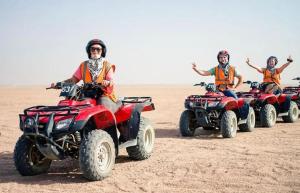a group of people riding atvs in the desert at Luxor Star ATV in Luxor