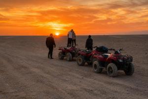 a group of people standing in the desert with atvs at Luxor Star ATV in Luxor
