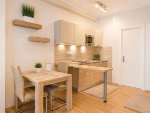 a kitchen with a wooden table and a dining room at Andy's Home Central Apatment in Budapest