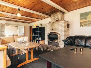 a living room with a table and a fireplace at 4 star holiday home in Aabybro in Åbybro +29 photos