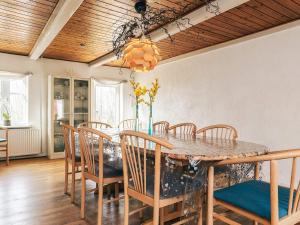 a dining room with a table and chairs at 4 star holiday home in Aabybro in Åbybro
