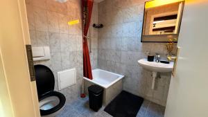 a small bathroom with a toilet and a sink at Golden Boutique in Basel