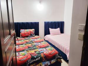 a small room with a bed and a twin bed at عين السلطان ain sultan in Imouzzer du Kandar
