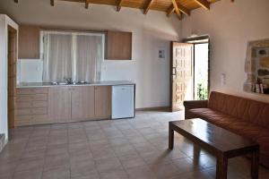 a living room with a couch and a table at Pegasus Resort in Agia Paraskevi