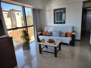 a living room with a couch and a coffee table at Reflejo de Mar in Villa Gesell